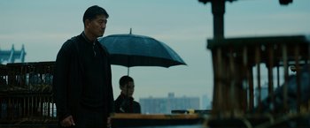 Movie still from “John Wick: Chapter 3 - Parabellum” (2019), directed by Chad Stahelski – A man and a woman under an open umbrella; Medium shot, Low angle