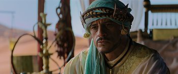 Movie still from “John Wick: Chapter 3 - Parabellum” (2019), directed by Chad Stahelski – A person wearing a turban; Close Up shot, Over the shoulder angle