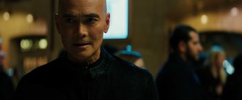 Movie still from “John Wick: Chapter 3 - Parabellum” (2019), directed by Chad Stahelski – A man with bald head wearing a black shirt; Close Up shot, Over the shoulder angle