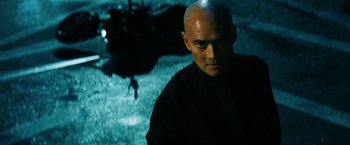 Movie still from “John Wick: Chapter 3 - Parabellum” (2019), directed by Chad Stahelski – A man with a bald head standing in front of a helicopter; Close Up shot, Low angle