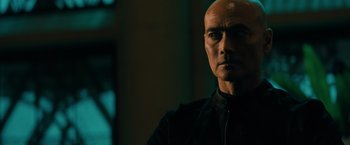 Movie still from “John Wick: Chapter 3 - Parabellum” (2019), directed by Chad Stahelski – A man with a bald head is looking at the camera; Close Up shot, Low angle