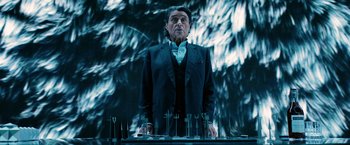 Movie still from “John Wick: Chapter 3 - Parabellum” (2019), directed by Chad Stahelski – A man standing in front of a bunch of glasses; Medium shot, Over the shoulder angle