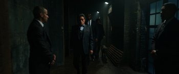 Movie still from “John Wick: Chapter 3 - Parabellum” (2019), directed by Chad Stahelski – A group of men walking down a dark hallway; Wide shot, Over the shoulder angle