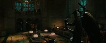 Movie still from “John Wick: Chapter 3 - Parabellum” (2019), directed by Chad Stahelski – A living room filled with furniture next to a window; Extreme Wide shot, High angle