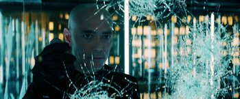 Movie still from “John Wick: Chapter 3 - Parabellum” (2019), directed by Chad Stahelski – A man with bald head standing in front of a shattered window; Close Up shot, Low angle