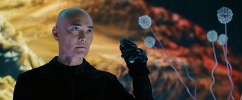 Movie still from “John Wick: Chapter 3 - Parabellum” (2019), directed by Chad Stahelski – A bald man in a black jacket holding a cell phone in his hand; Close Up shot, Low angle