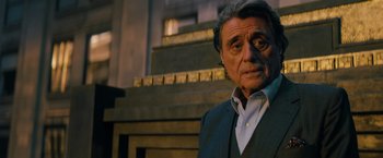 Movie still from “John Wick: Chapter 3 - Parabellum” (2019), directed by Chad Stahelski – An older man wearing a suit and a white dress shirt; Close Up shot, Over the shoulder angle