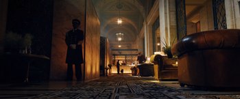 Movie still from “John Wick: Chapter 3 - Parabellum” (2019), directed by Chad Stahelski – A hotel lobby with people and a dog in it; Wide shot, Low angle