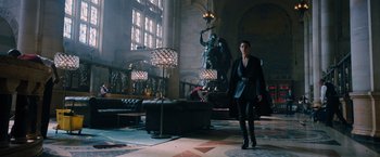 Movie still from “John Wick: Chapter 3 - Parabellum” (2019), directed by Chad Stahelski – A woman is standing in a room with a lot of furniture; Wide shot, Low angle