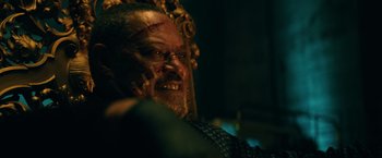 Movie still from “John Wick: Chapter 3 - Parabellum” (2019), directed by Chad Stahelski – A man with a beard and a scar on his face; Close Up shot, Low angle