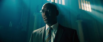 Movie still from “John Wick: Chapter 4” (2023), directed by Chad Stahelski – A man in a suit and tie standing in front of a window; Close Up shot, Low angle