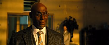 Movie still from “John Wick: Chapter 4” (2023), directed by Chad Stahelski – A man in a suit and tie standing in front of another man; Close Up shot, Over the shoulder angle