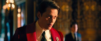 Movie still from “John Wick: Chapter 4” (2023), directed by Chad Stahelski – A man in a suit and tie looking at the camera; Close Up shot, Low angle