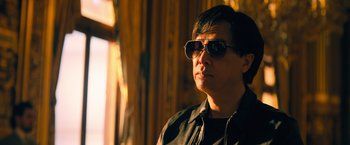 Movie still from “John Wick: Chapter 4” (2023), directed by Chad Stahelski – A man wearing sunglasses and a black jacket; Close Up shot, Low angle