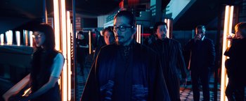 Movie still from “John Wick: Chapter 4” (2023), directed by Chad Stahelski – A group of people standing around in a room; Medium shot, Low angle