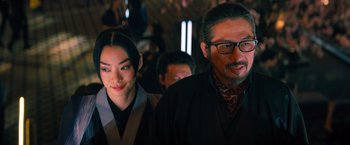 Movie still from “John Wick: Chapter 4” (2023), directed by Chad Stahelski – A man and a woman standing next to each other; Close Up shot, Over the shoulder angle