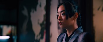 Movie still from “John Wick: Chapter 4” (2023), directed by Chad Stahelski – A young asian woman in a black and white outfit; Close Up shot, Low angle