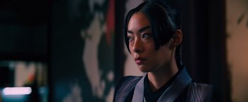 Movie still from “John Wick: Chapter 4” (2023), directed by Chad Stahelski – A young asian woman in a black and white outfit; Close Up shot, Low angle