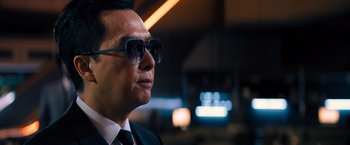 Movie still from “John Wick: Chapter 4” (2023), directed by Chad Stahelski – A person wearing a suit and sunglasses; Close Up shot, Low angle