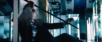 Movie still from “John Wick: Chapter 4” (2023), directed by Chad Stahelski – A man in a suit and tie holding a cane; Medium shot, Low angle