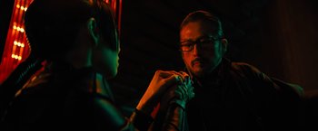 Movie still from “John Wick: Chapter 4” (2023), directed by Chad Stahelski – A man and a woman holding hands in a dark room; Close Up shot, Over the shoulder angle