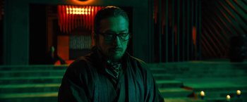 Movie still from “John Wick: Chapter 4” (2023), directed by Chad Stahelski – A man with a beard wearing a suit and tie; Close Up shot, Low angle