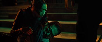 Movie still from “John Wick: Chapter 4” (2023), directed by Chad Stahelski – A man and a woman in a dark room; Medium shot, Low angle