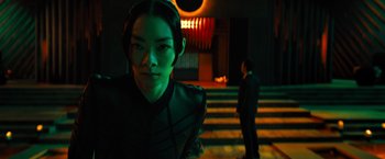 Movie still from “John Wick: Chapter 4” (2023), directed by Chad Stahelski – A woman in a black outfit standing in front of stairs; Close Up shot, Over the shoulder angle
