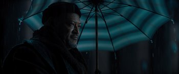 Movie still from “John Wick: Chapter 4” (2023), directed by Chad Stahelski – A man standing under an umbrella in the dark; Close Up shot, Low angle