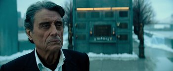 Movie still from “John Wick: Chapter 4” (2023), directed by Chad Stahelski – An older man wearing a suit and white shirt; Close Up shot, Over the shoulder angle