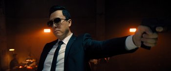 Movie still from “John Wick: Chapter 4” (2023), directed by Chad Stahelski – A man in a suit and tie with sunglasses on; Close Up shot, Low angle