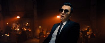 Movie still from “John Wick: Chapter 4” (2023), directed by Chad Stahelski – A man in a suit and sunglasses in a dark room; Close Up shot, Low angle