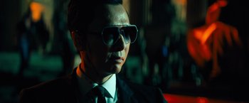 Movie still from “John Wick: Chapter 4” (2023), directed by Chad Stahelski – A person wearing a suit and sunglasses; Close Up shot, Low angle