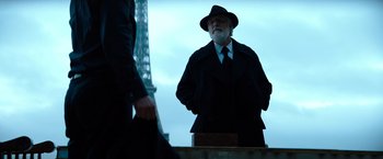 Movie still from “John Wick: Chapter 4” (2023), directed by Chad Stahelski – An older man in a hat and a suit; Medium shot, Low angle