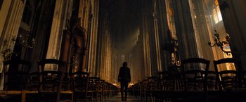 Movie still from “John Wick: Chapter 4” (2023), directed by Chad Stahelski – A man walking down a long aisle in a church; Extreme Wide shot, Low angle