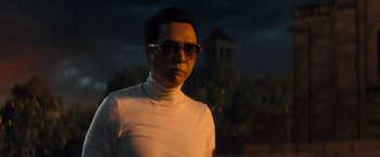 Movie still from “John Wick: Chapter 4” (2023), directed by Chad Stahelski – A man wearing a white shirt and sunglasses; Close Up shot, Over the shoulder angle