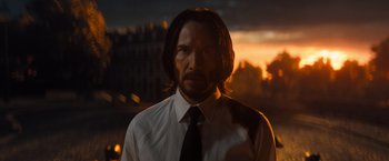 Movie still from “John Wick: Chapter 4” (2023), directed by Chad Stahelski – A man in a white shirt and a black tie; Close Up shot, Low angle
