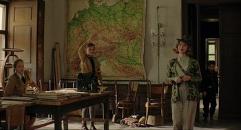 Movie still from “Jojo Rabbit” (2019), directed by Taika Waititi – A man and a woman standing in front of a map; Wide shot, Low angle