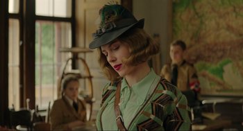Movie still from “Jojo Rabbit” (2019), directed by Taika Waititi – A young woman wearing a hat with feathers on it; Medium shot, Over the shoulder angle
