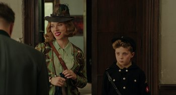 Movie still from “Jojo Rabbit” (2019), directed by Taika Waititi – A woman and a boy are standing next to each other; Medium shot, Over the shoulder angle