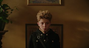 Movie still from “Jojo Rabbit” (2019), directed by Taika Waititi – A young boy wearing a black coat and a red tie; Close Up shot, Over the shoulder angle