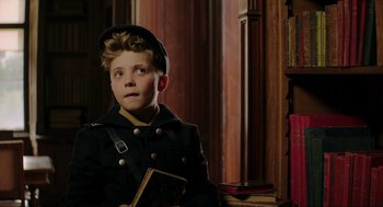 Movie still from “Jojo Rabbit” (2019), directed by Taika Waititi – A young boy in a military uniform holding a book; Close Up shot, Over the shoulder angle