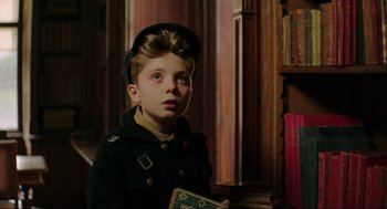 Movie still from “Jojo Rabbit” (2019), directed by Taika Waititi – A young boy in a military uniform holding a book; Close Up shot, Over the shoulder angle