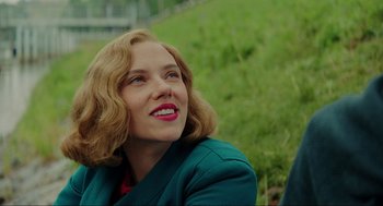 Movie still from “Jojo Rabbit” (2019), directed by Taika Waititi – A person wearing a suit and smiling; Close Up shot, Over the shoulder angle