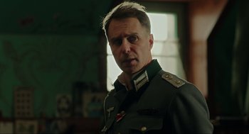 Movie still from “Jojo Rabbit” (2019), directed by Taika Waititi – A person wearing a military uniform; Close Up shot, Over the shoulder angle