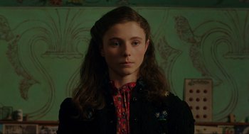 Movie still from “Jojo Rabbit” (2019), directed by Taika Waititi – A young girl with long brown hair wearing a black jacket; Close Up shot, Low angle