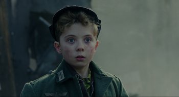 Movie still from “Jojo Rabbit” (2019), directed by Taika Waititi – A young boy wearing a green jacket and a hat; Close Up shot, Over the shoulder angle