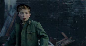 Movie still from “Jojo Rabbit” (2019), directed by Taika Waititi – A young boy wearing a green jacket and a hat; Close Up shot, Over the shoulder angle