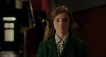 Movie still from “Jojo Rabbit” (2019), directed by Taika Waititi – A woman in a green jacket and a plaid shirt; Close Up shot, Over the shoulder angle