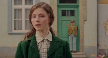 Movie still from “Jojo Rabbit” (2019), directed by Taika Waititi – A young girl standing in front of a green door; Close Up shot, Over the shoulder angle